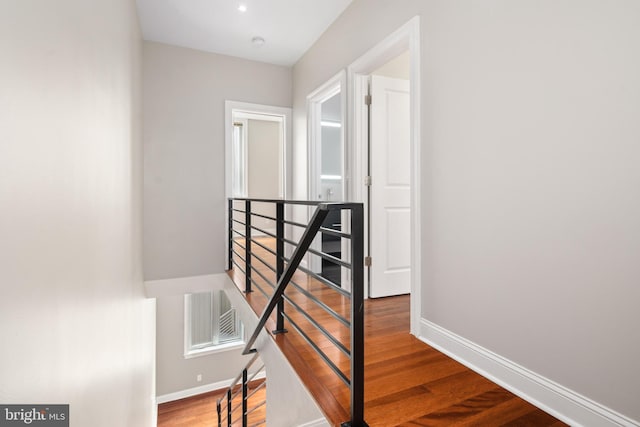 staircase featuring visible vents, baseboards, and wood finished floors