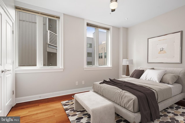 bedroom with wood finished floors and baseboards