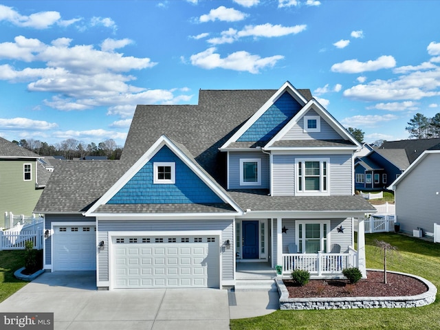 view of front of home with fence, a porch, roof with shingles, driveway, and an attached garage