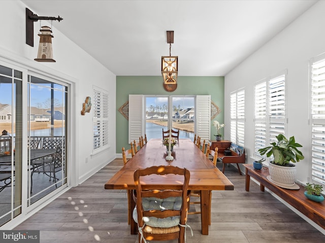 dining area with baseboards and wood finished floors