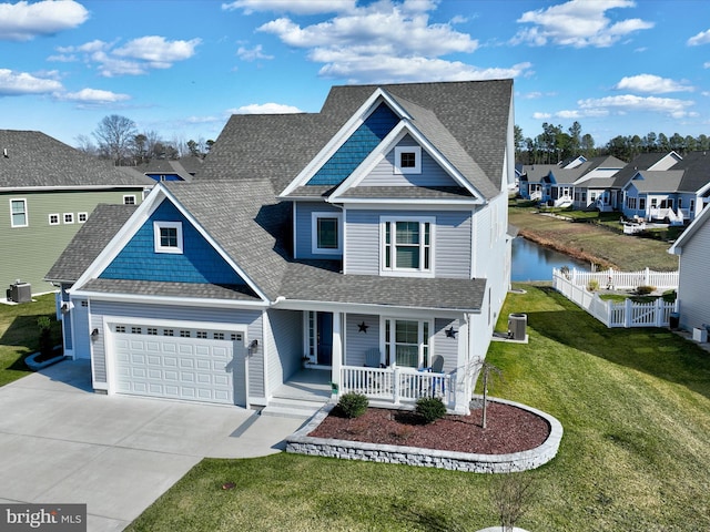 view of front of property with fence, covered porch, concrete driveway, a front lawn, and central air condition unit