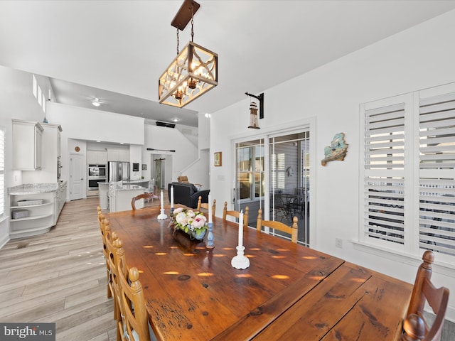 dining area featuring an inviting chandelier and light wood-type flooring