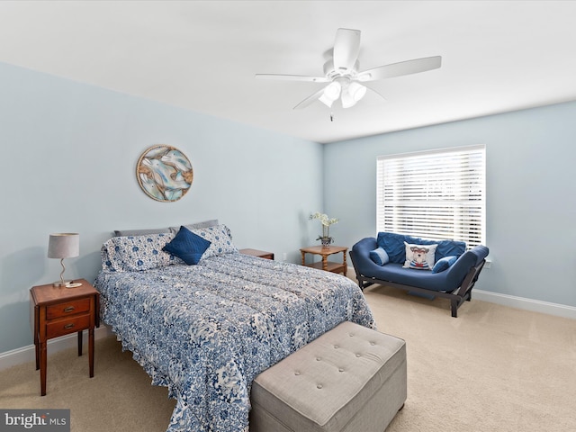 carpeted bedroom with a ceiling fan and baseboards