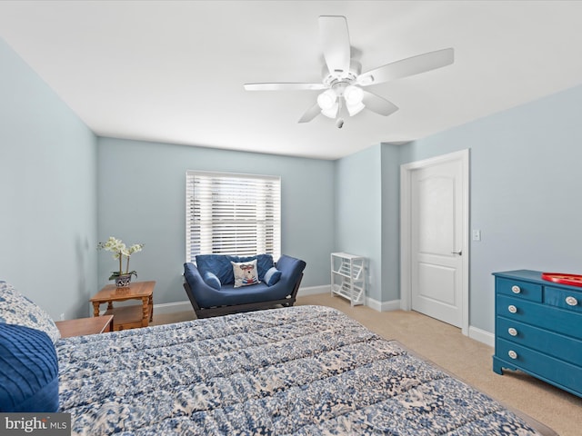 carpeted bedroom featuring baseboards and ceiling fan