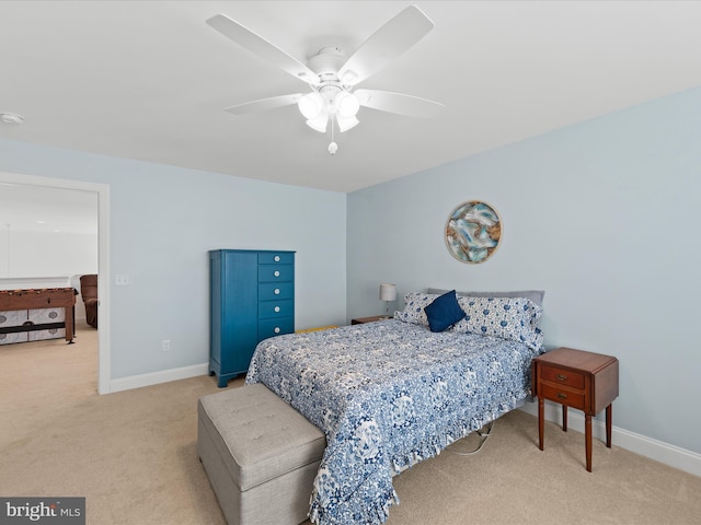 carpeted bedroom featuring baseboards and ceiling fan