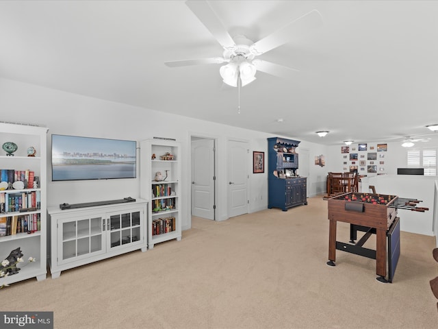 recreation room with carpet and ceiling fan