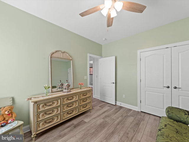 bedroom featuring baseboards, ceiling fan, and light wood finished floors