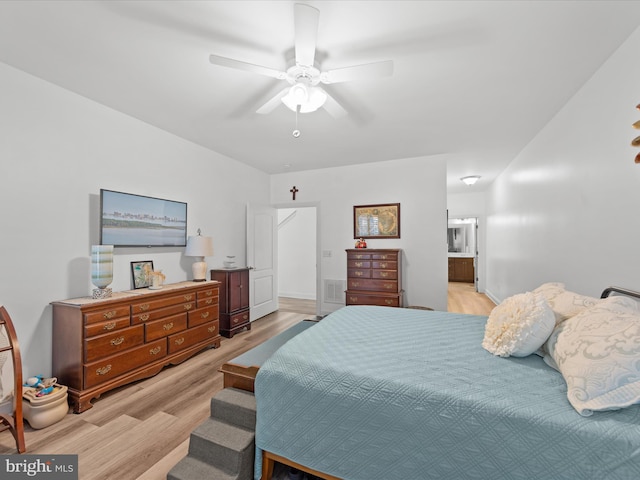 bedroom with light wood-style flooring, ensuite bath, and ceiling fan