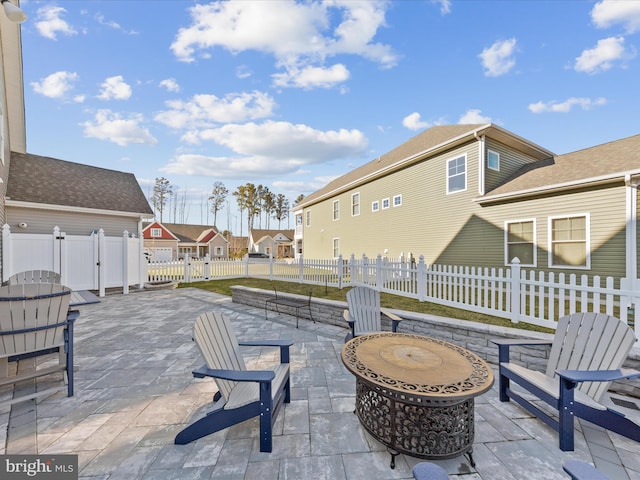 view of patio / terrace featuring a residential view, a fenced backyard, and a gate