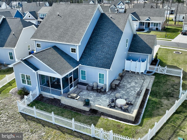 birds eye view of property with a residential view