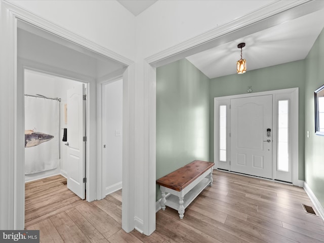 entrance foyer featuring visible vents, baseboards, and light wood-style floors