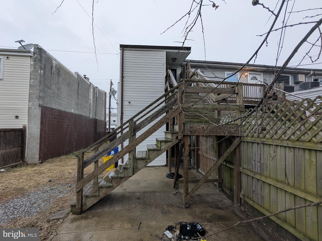 rear view of property with stairway and fence