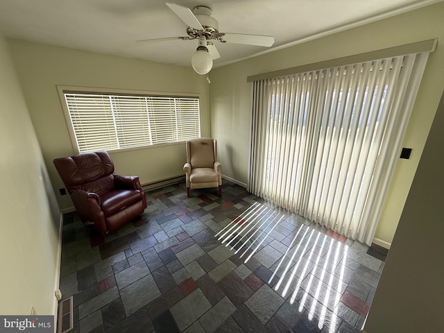 living area with ceiling fan, baseboards, visible vents, and stone tile floors