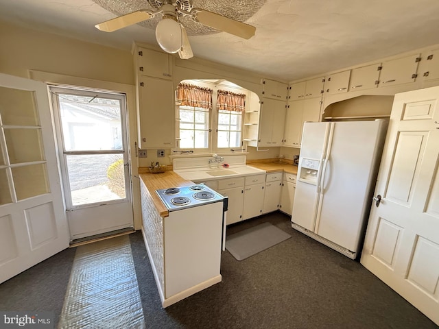 kitchen with white refrigerator with ice dispenser, a sink, white cabinetry, light countertops, and stovetop