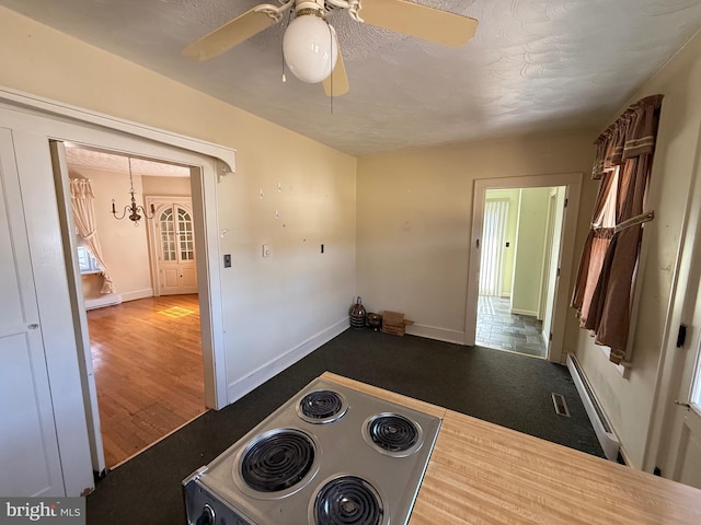 kitchen with white range with electric cooktop, baseboard heating, ceiling fan, wood finished floors, and baseboards