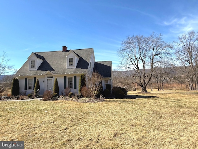 cape cod house with a front lawn