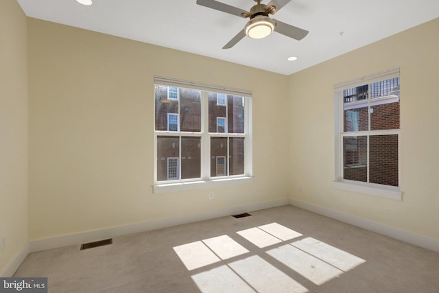 carpeted empty room with visible vents, recessed lighting, and baseboards