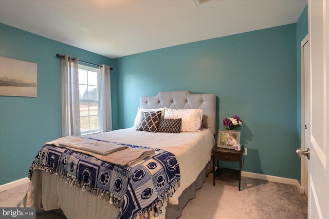 bedroom featuring baseboards and carpet flooring