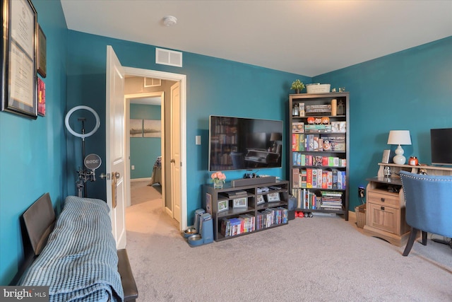 interior space with carpet floors, visible vents, and attic access