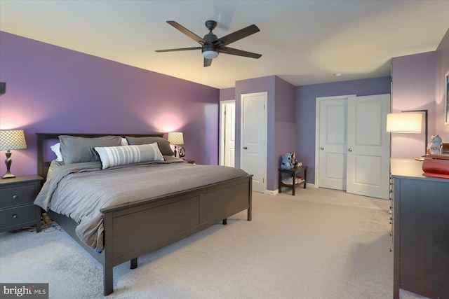 bedroom featuring ceiling fan, baseboards, and light colored carpet