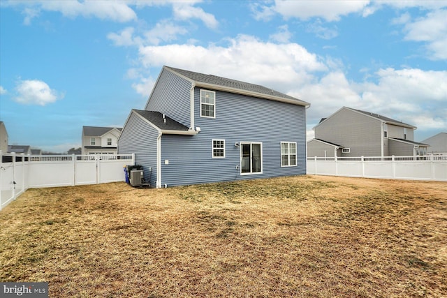 back of house featuring cooling unit, a fenced backyard, and a yard