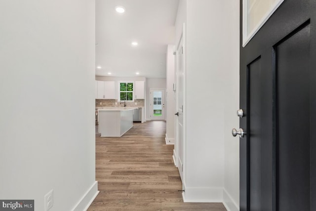 entryway featuring baseboards, recessed lighting, and light wood-style floors