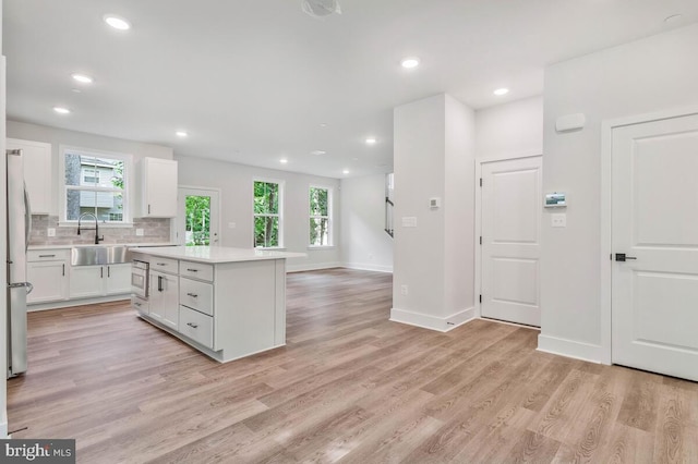 kitchen featuring plenty of natural light, tasteful backsplash, stainless steel appliances, and a sink