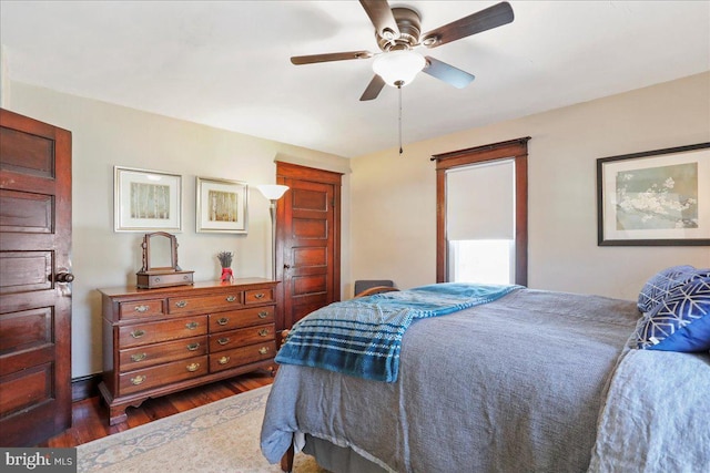 bedroom featuring dark wood-style flooring and ceiling fan