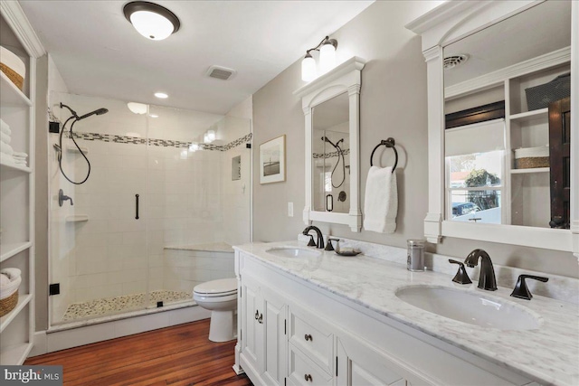 full bath with toilet, a stall shower, a sink, and visible vents