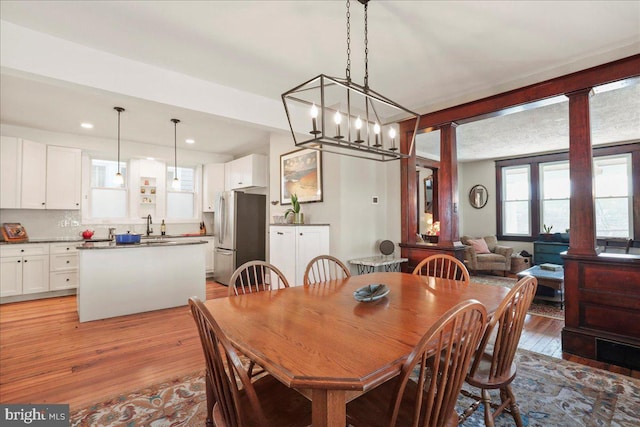 dining space with light wood-style flooring and recessed lighting