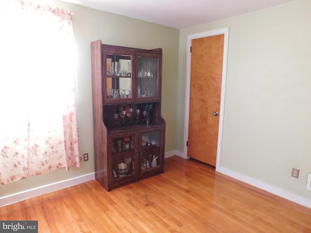 interior space featuring light wood-style flooring and baseboards