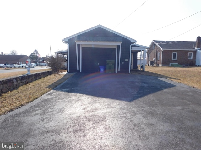 garage with driveway and central AC