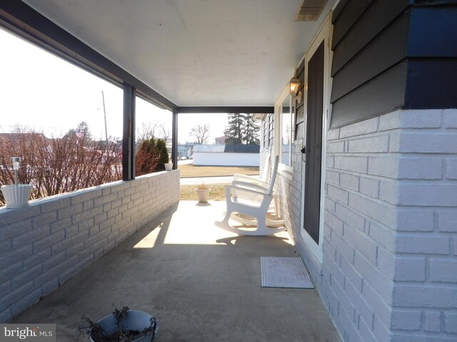 view of patio with visible vents and a porch