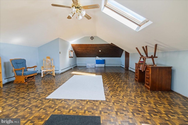 additional living space with ceiling fan, vaulted ceiling with skylight, and a baseboard radiator