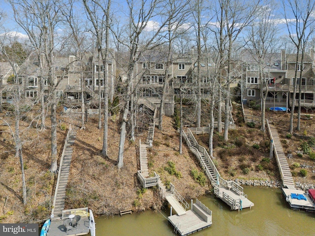 exterior space with a residential view, stairs, and a water view