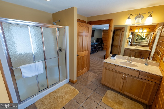 bathroom with tile patterned floors, a stall shower, and vanity