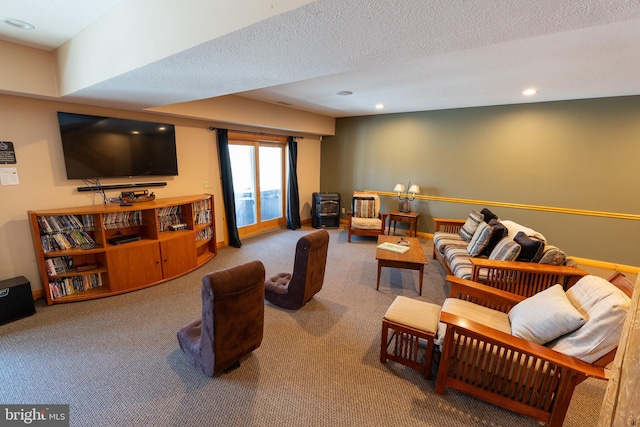 living room with recessed lighting, a textured ceiling, a wood stove, and carpet