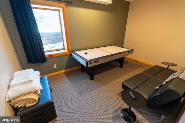 recreation room featuring baseboards and carpet floors