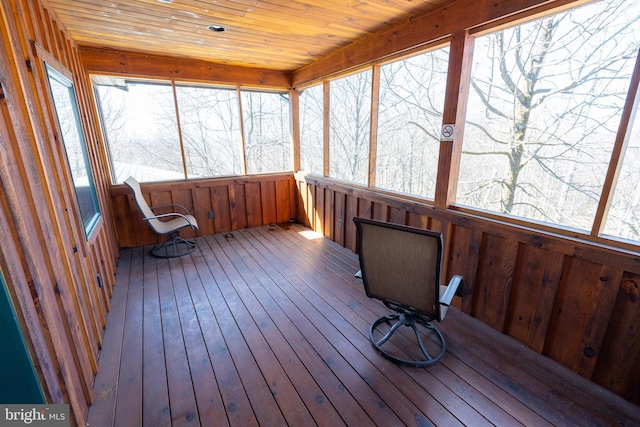 sunroom featuring plenty of natural light and wood ceiling