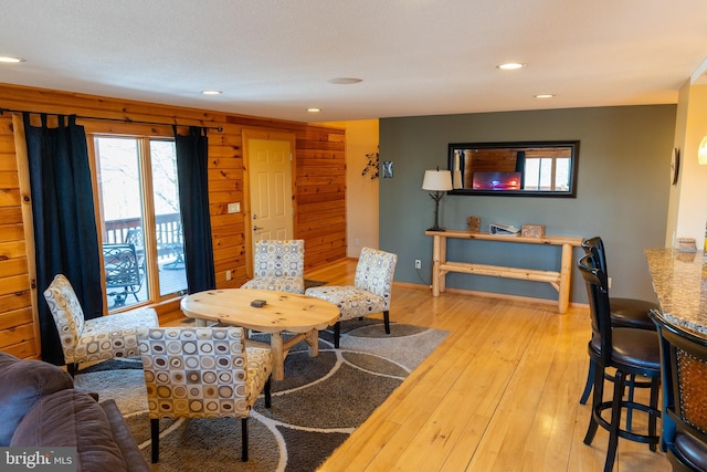 living room with hardwood / wood-style floors, recessed lighting, and baseboards