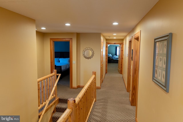 hallway featuring recessed lighting, baseboards, and light colored carpet