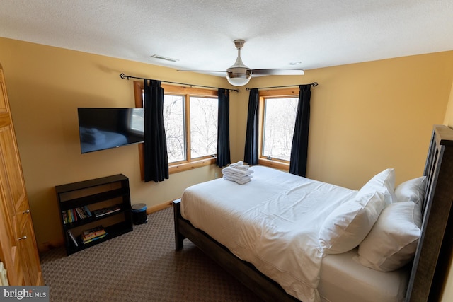 carpeted bedroom with baseboards, visible vents, and a textured ceiling