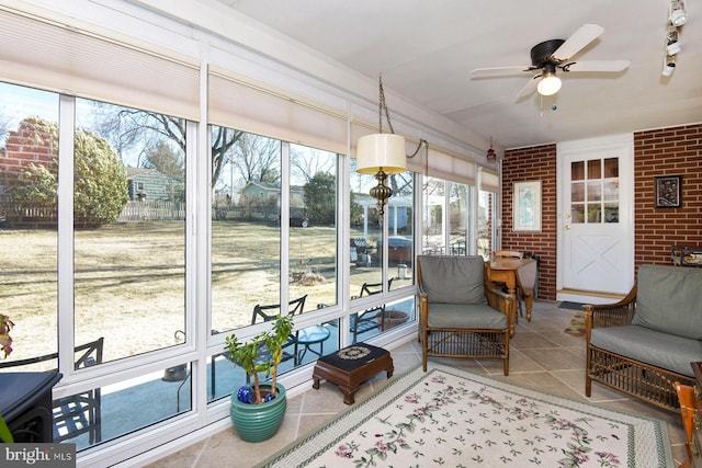 sunroom / solarium featuring ceiling fan