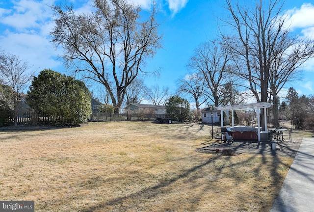 view of yard featuring a patio, fence, a pergola, and a hot tub