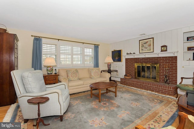 living area with visible vents, baseboard heating, wood finished floors, and a fireplace