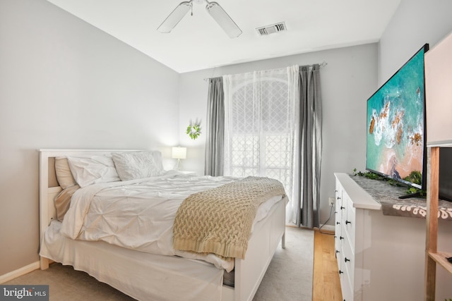 bedroom with visible vents, baseboards, light wood-type flooring, and ceiling fan