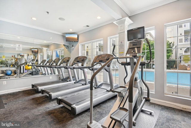 workout area featuring a healthy amount of sunlight, decorative columns, and ornamental molding