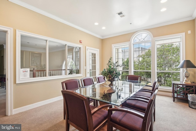 dining space with visible vents, carpet floors, and ornamental molding