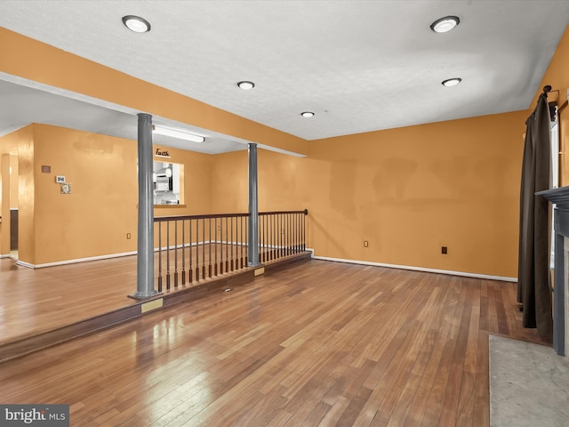 interior space with wood-type flooring and baseboards