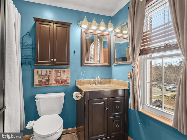 bathroom featuring baseboards, vanity, and toilet